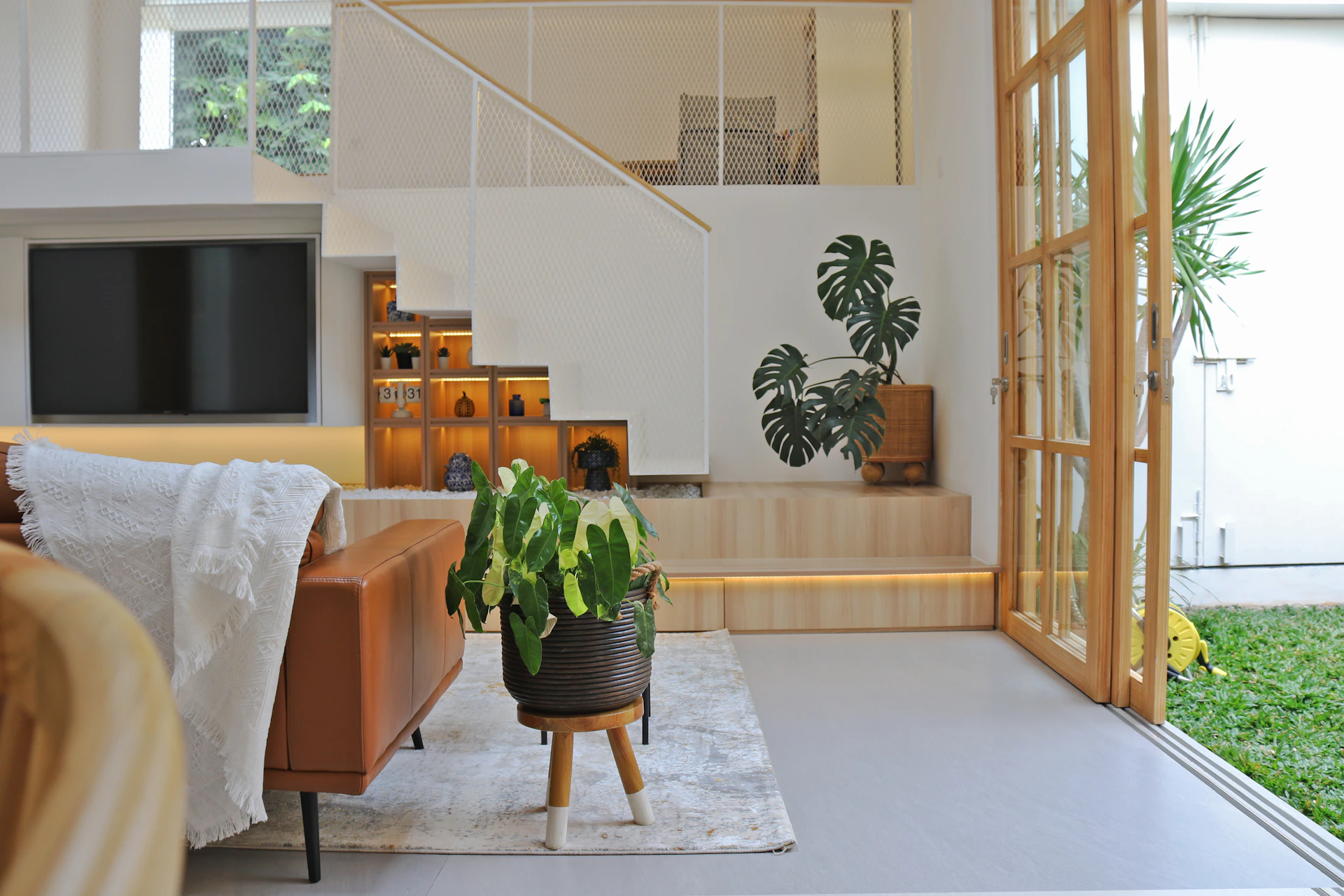 a living room filled with furniture and a flat screen tv