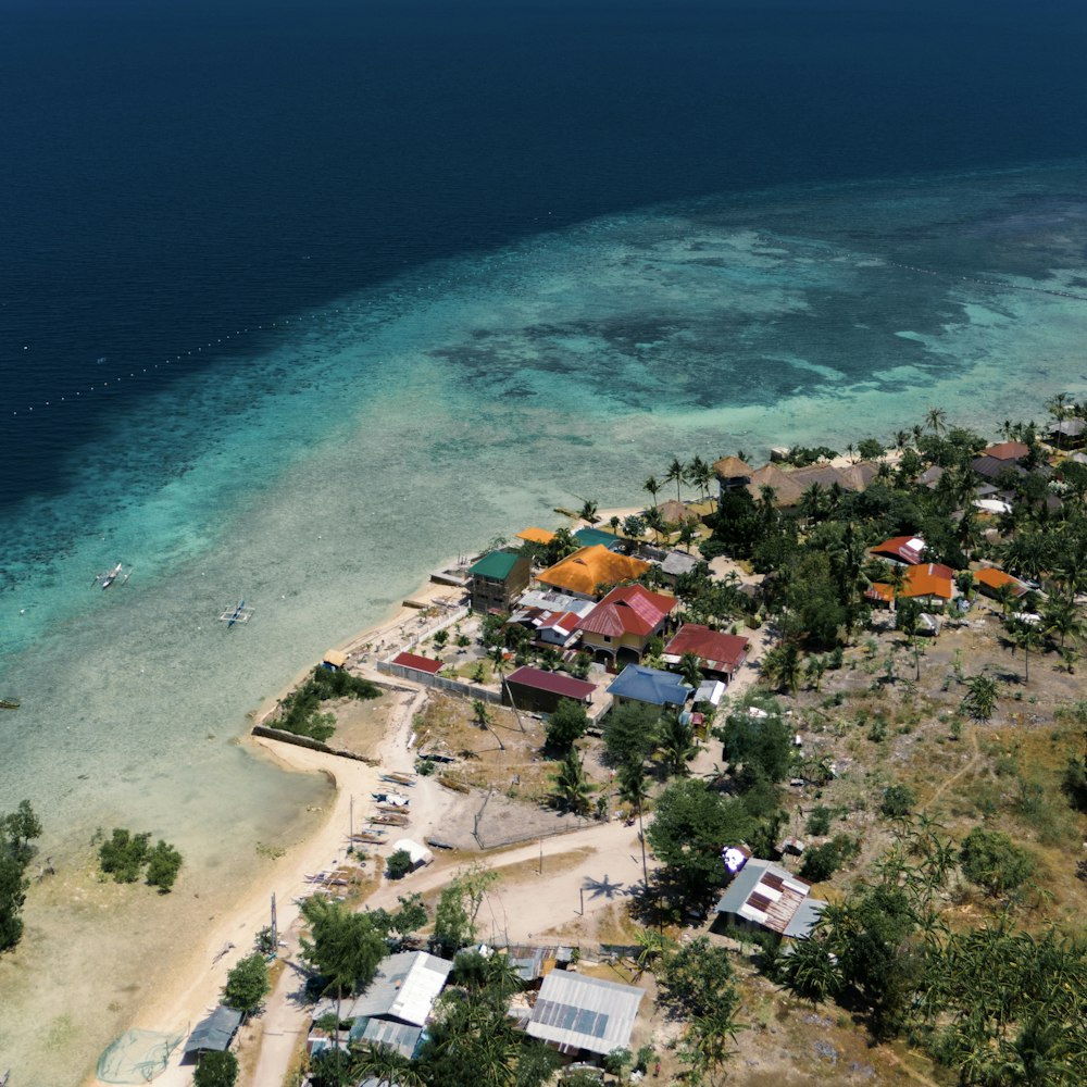 an aerial view of a small village by the ocean