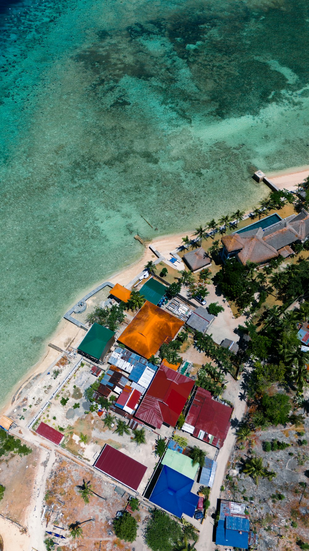 an aerial view of a small village on a beach