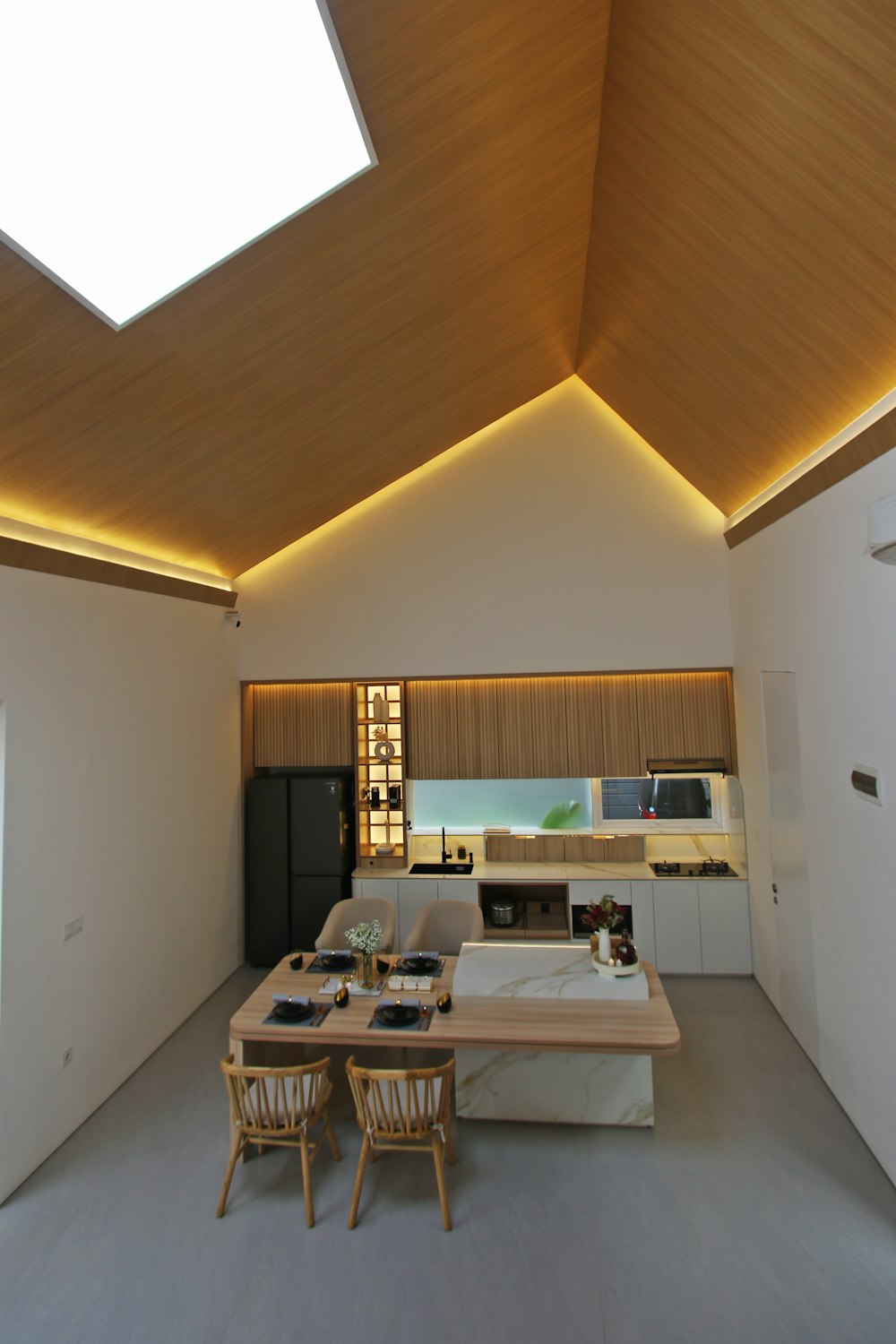 a living room filled with furniture and a skylight