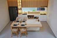 a kitchen with a table and chairs and a refrigerator