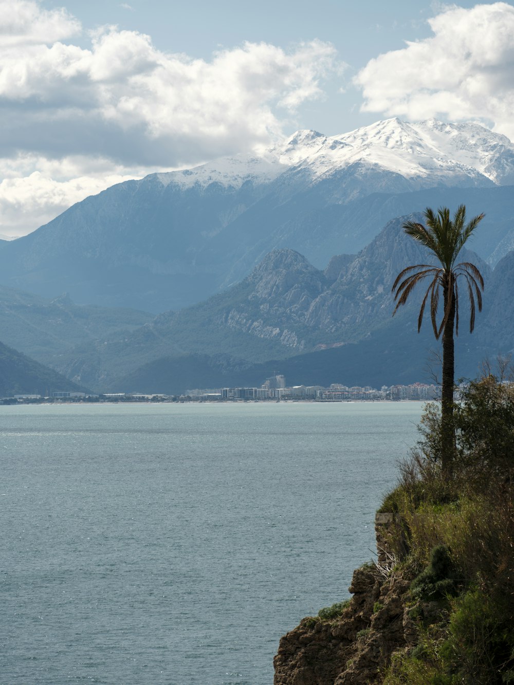 a large body of water with mountains in the background