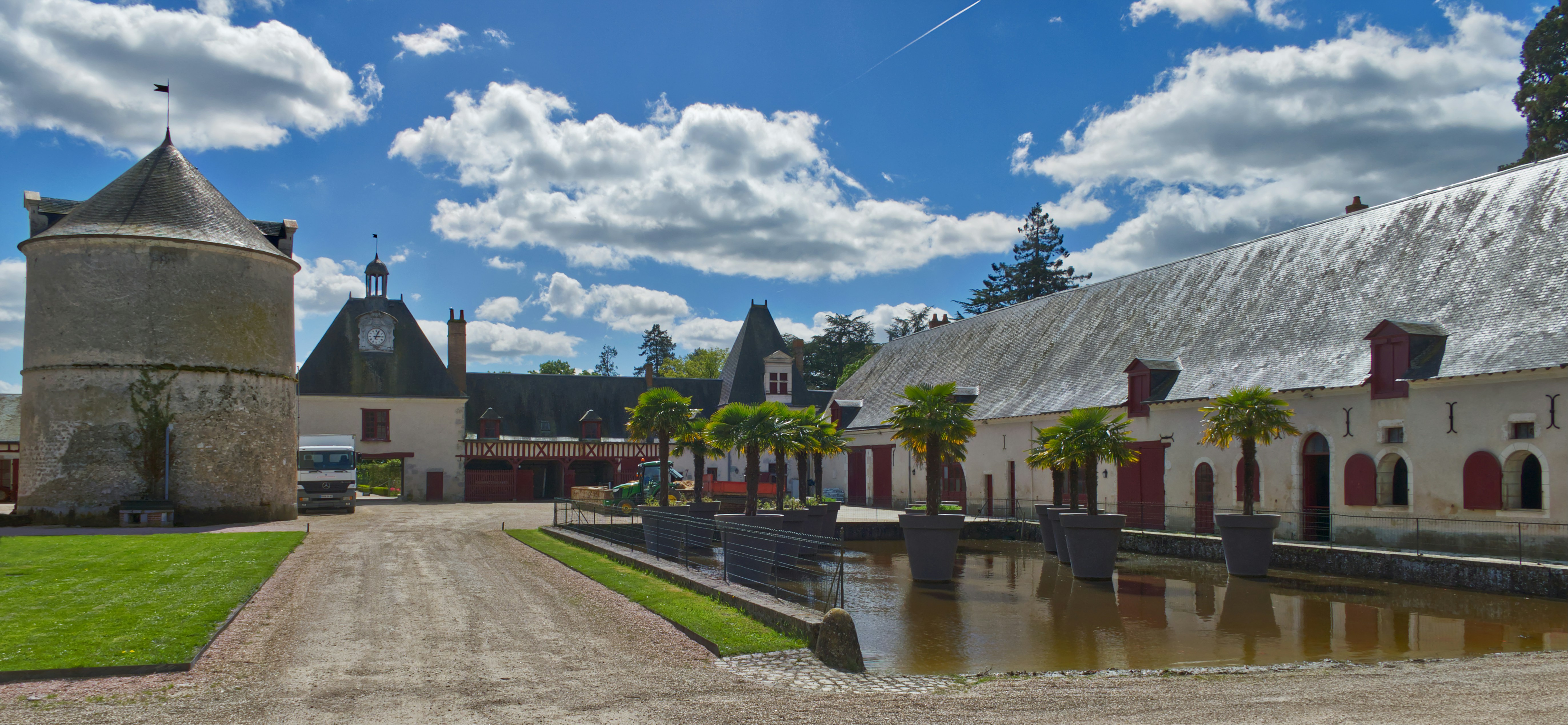 a large building with a tower next to a body of water