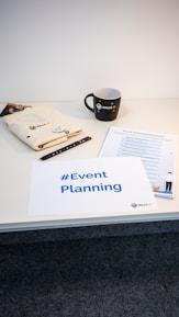 a table with a coffee cup and a sign on it