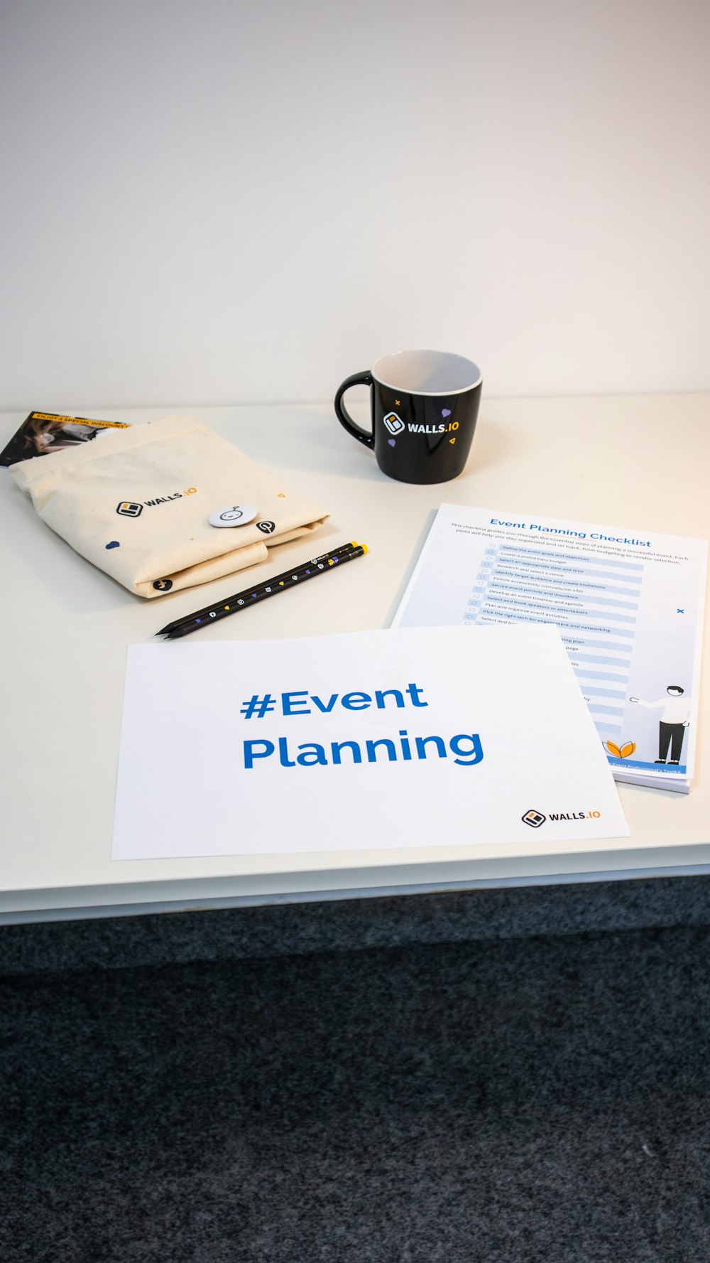 a table with a coffee cup and a sign on it