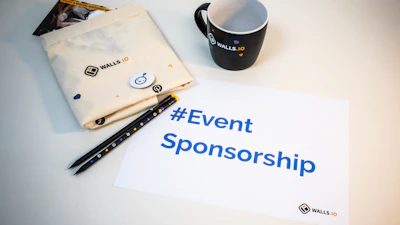a cup of coffee next to a sign that says event sponsor