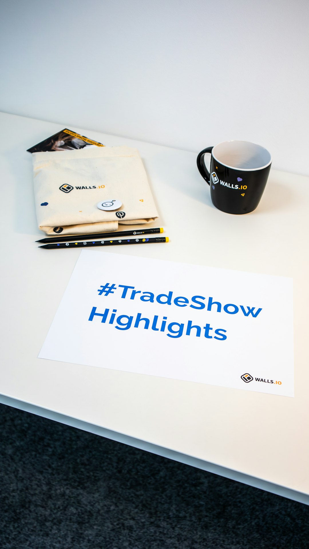 A collection of branded merch and freebies for events with the hashtag #TradeShowHighlights