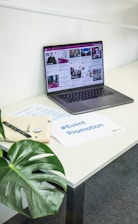 a laptop computer sitting on top of a white desk