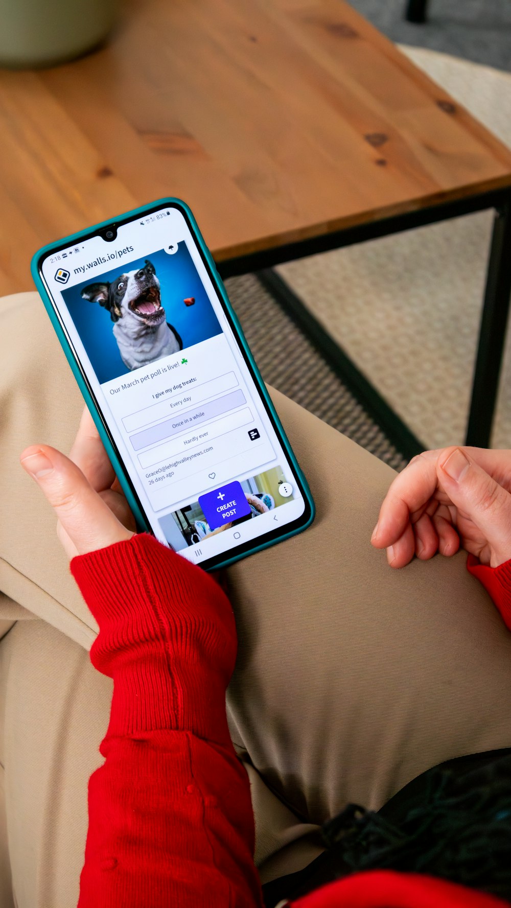 a person holding a cell phone with a dog on the screen