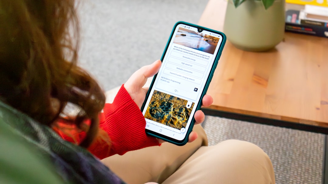 Person browsing a social wall on a smartphone and voting on an live poll