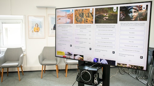 a large screen in a room with chairs