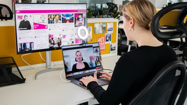 a woman sitting at a desk using a laptop computer