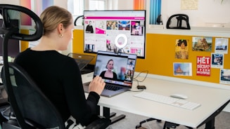 a woman sitting at a desk with a laptop computer
