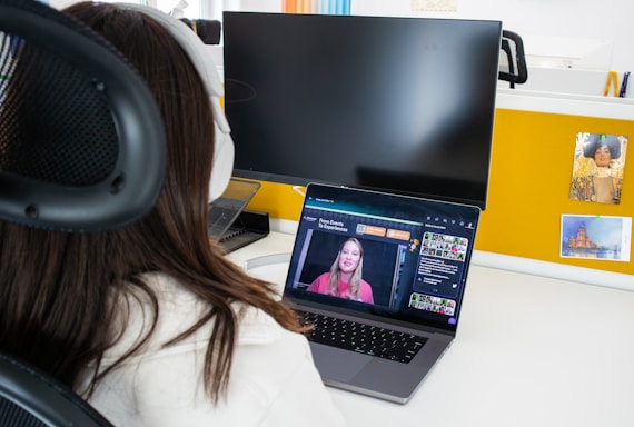 a woman sitting in front of a laptop computer