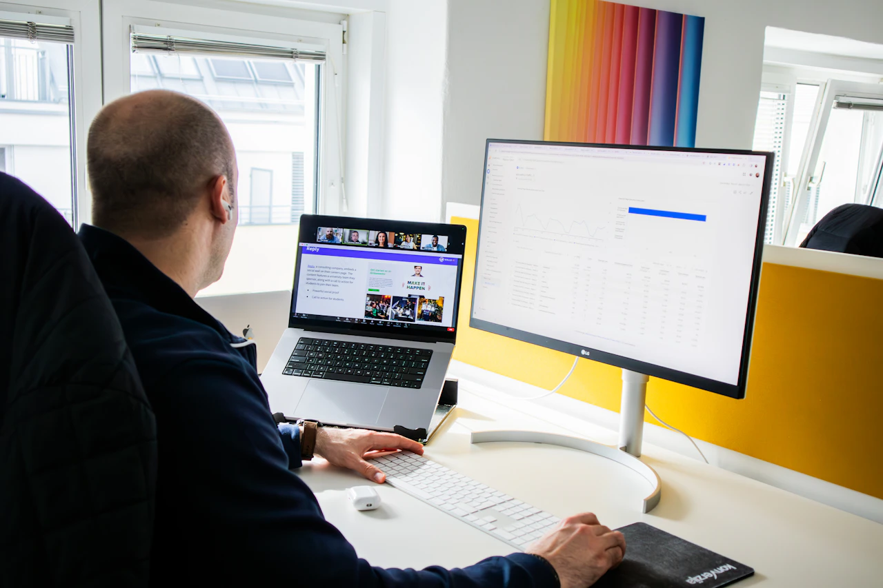 Man working at laptop and monitor