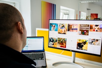 a man sitting in front of a computer monitor