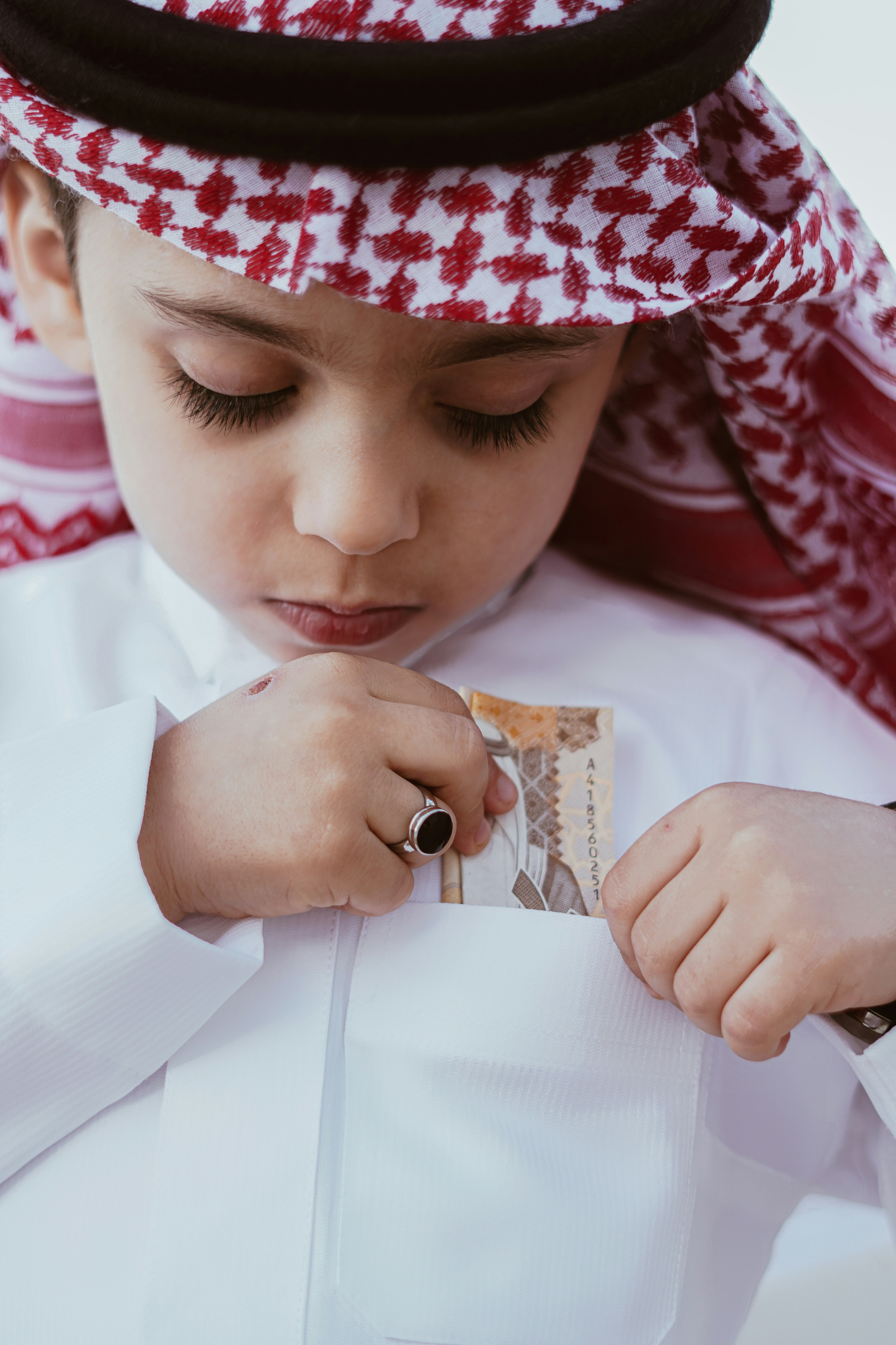 A young boy wearing a white shirt and a red and white hat photo – Free ...