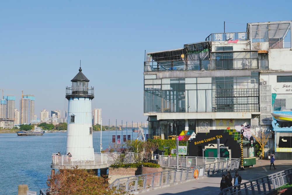 a light house next to a body of water