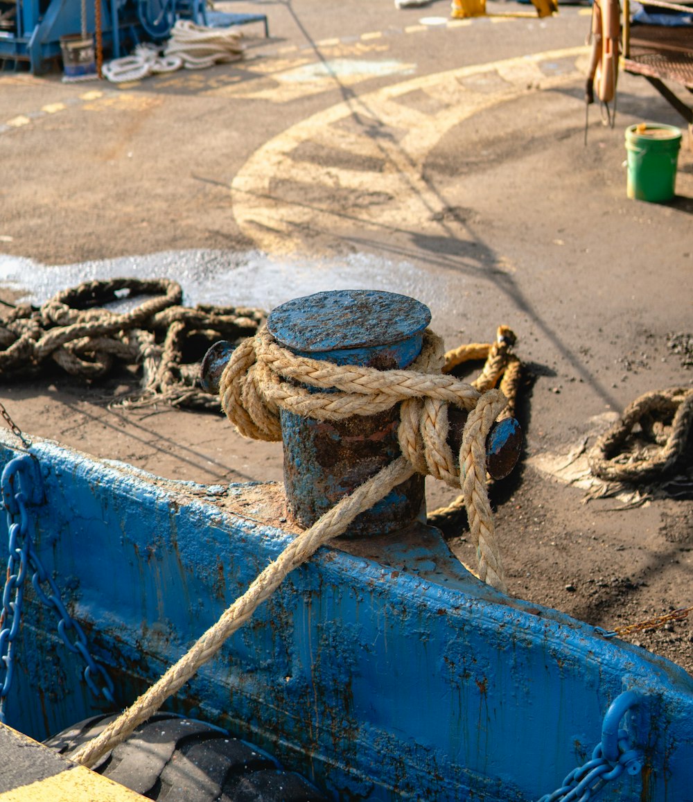 a blue boat with a rope tied to it