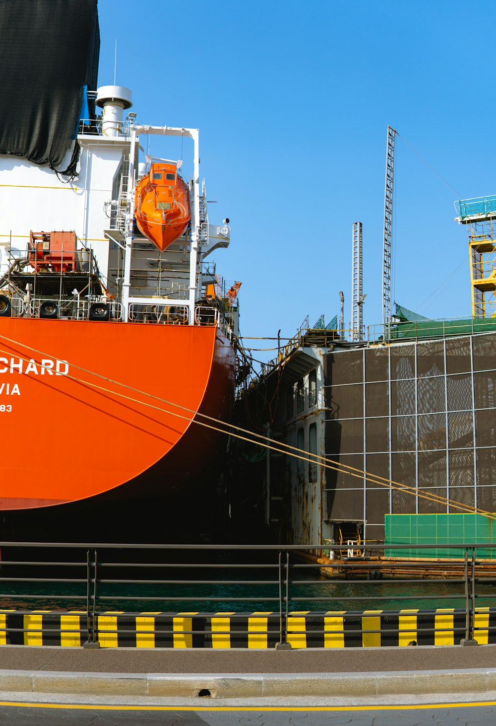 a large orange boat sitting in a dry dock
