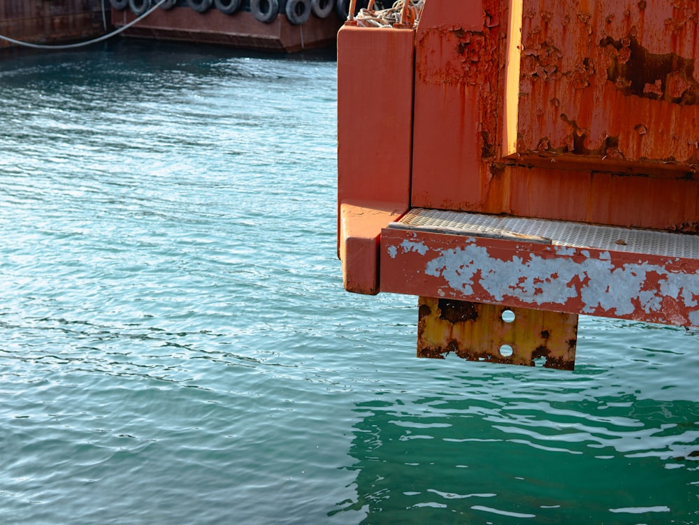 a rusted metal beam sticking out of the water