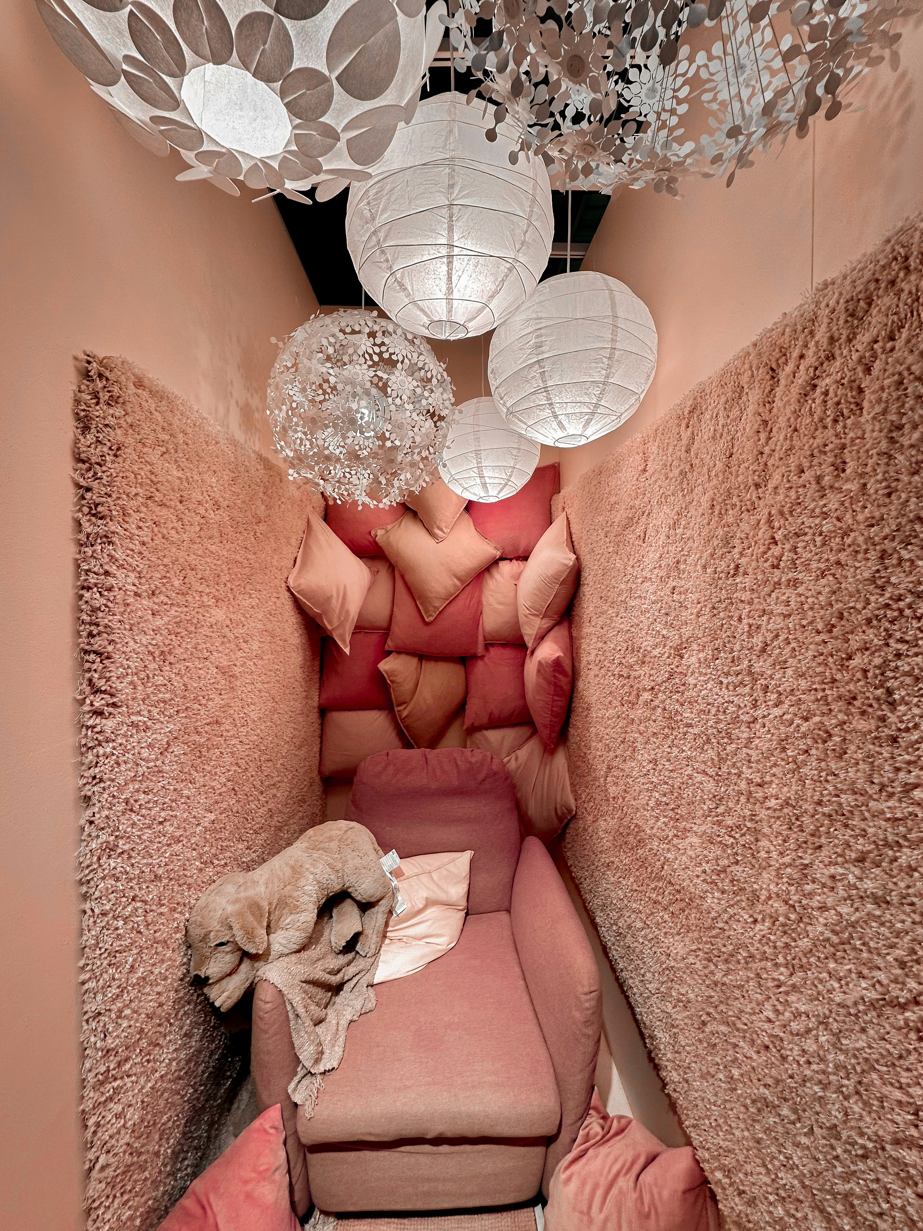 Soft pastel room interior with pink walls and cozy furniture