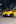 a yellow sports car parked on the side of the road