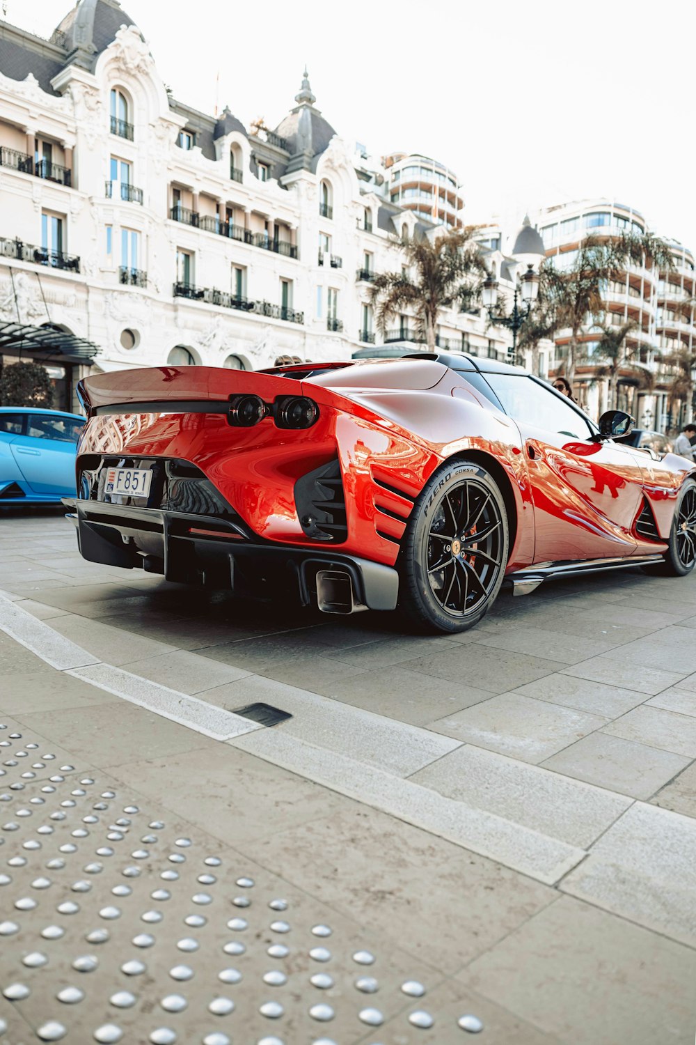 a red sports car parked in front of a building