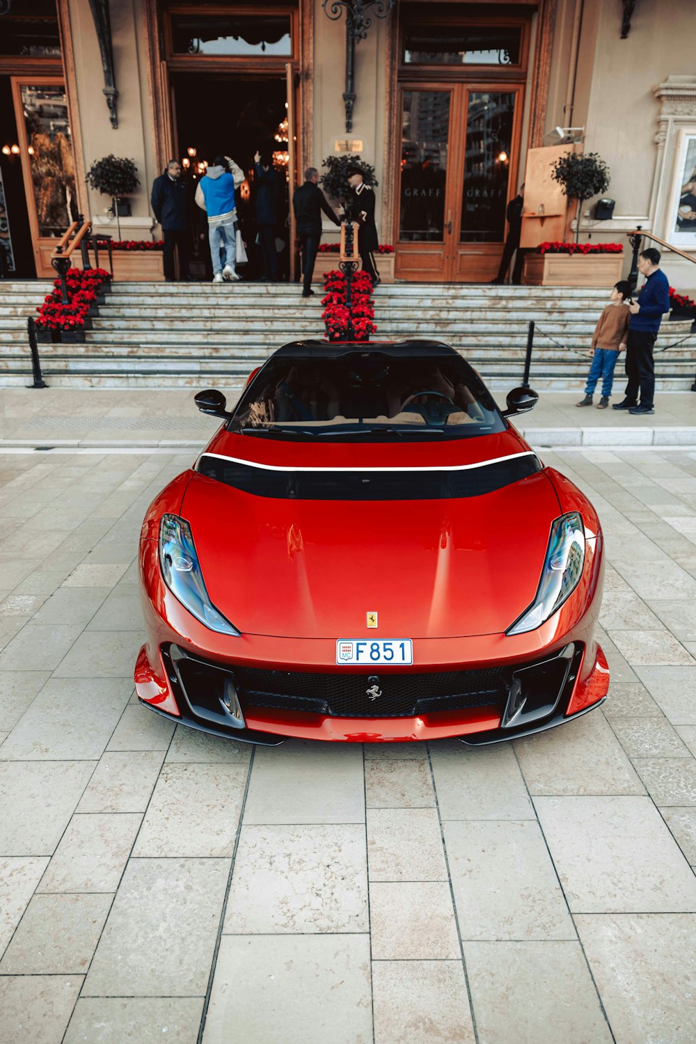 a red sports car parked in front of a building