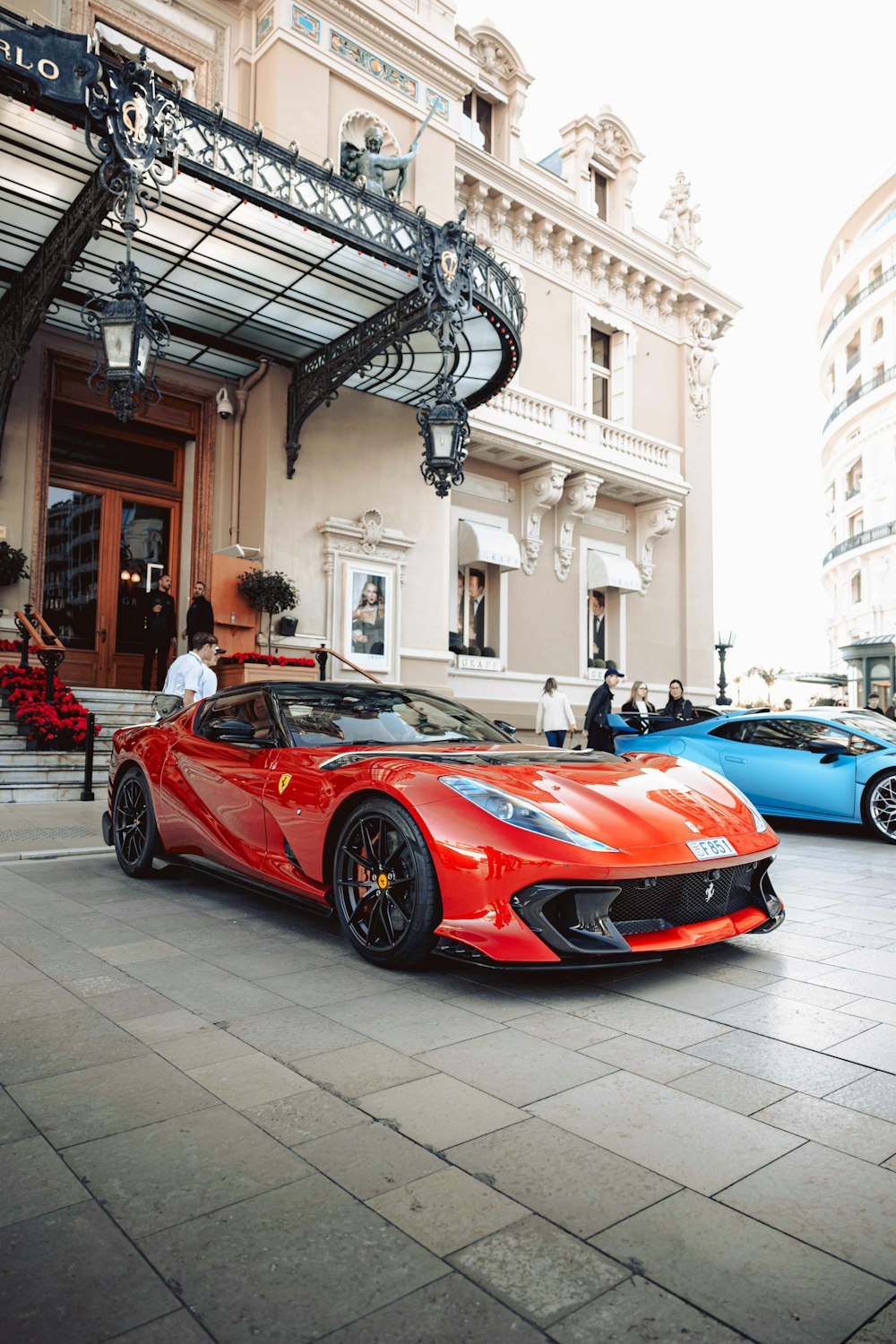 a red sports car parked in front of a building