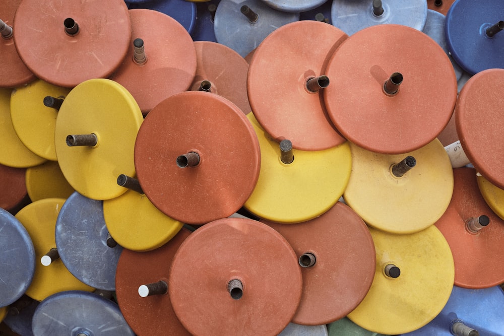 a pile of different colored discs with holes in them
