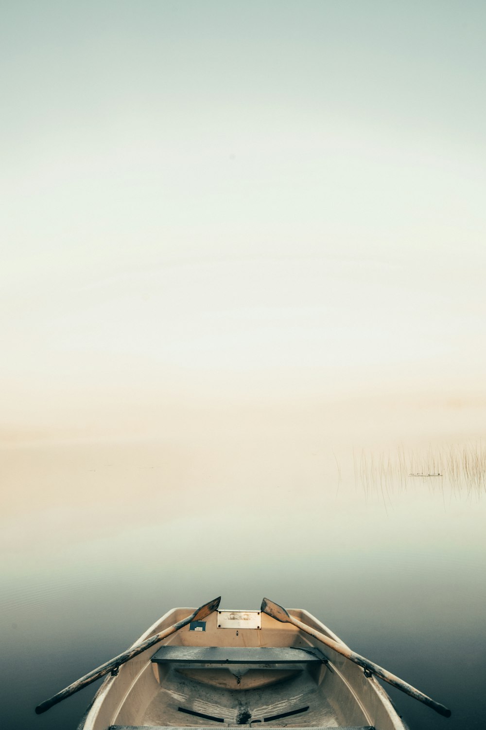 a small boat floating on top of a body of water