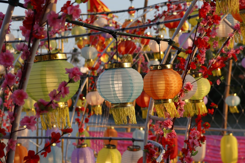 a bunch of colorful lanterns hanging from a pole