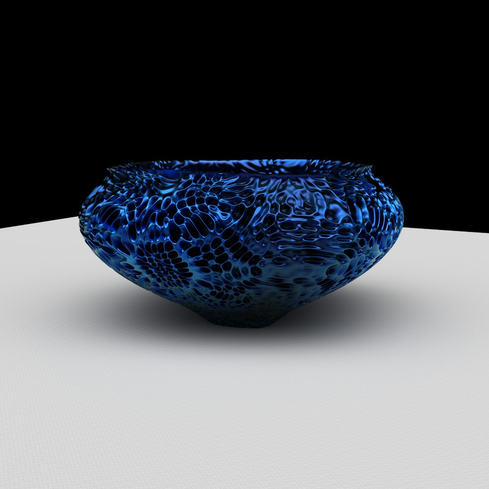a blue bowl sitting on top of a white table