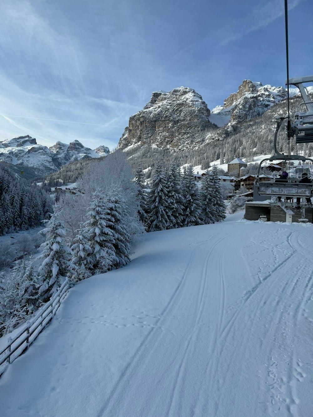 a ski lift going up a snowy mountain