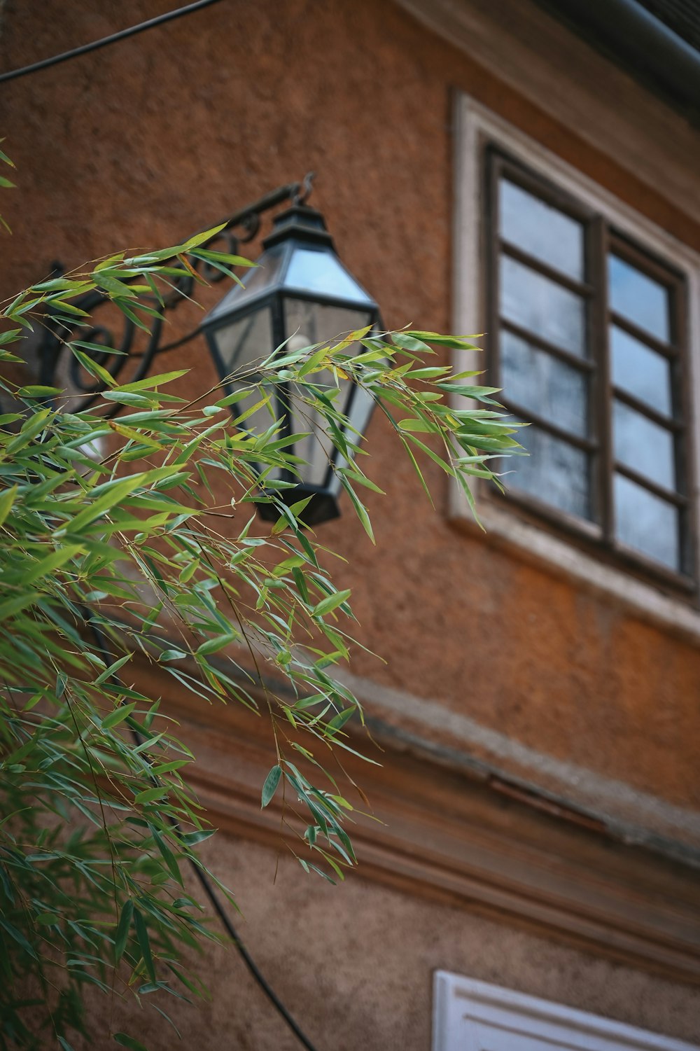 a lamp hanging from the side of a building