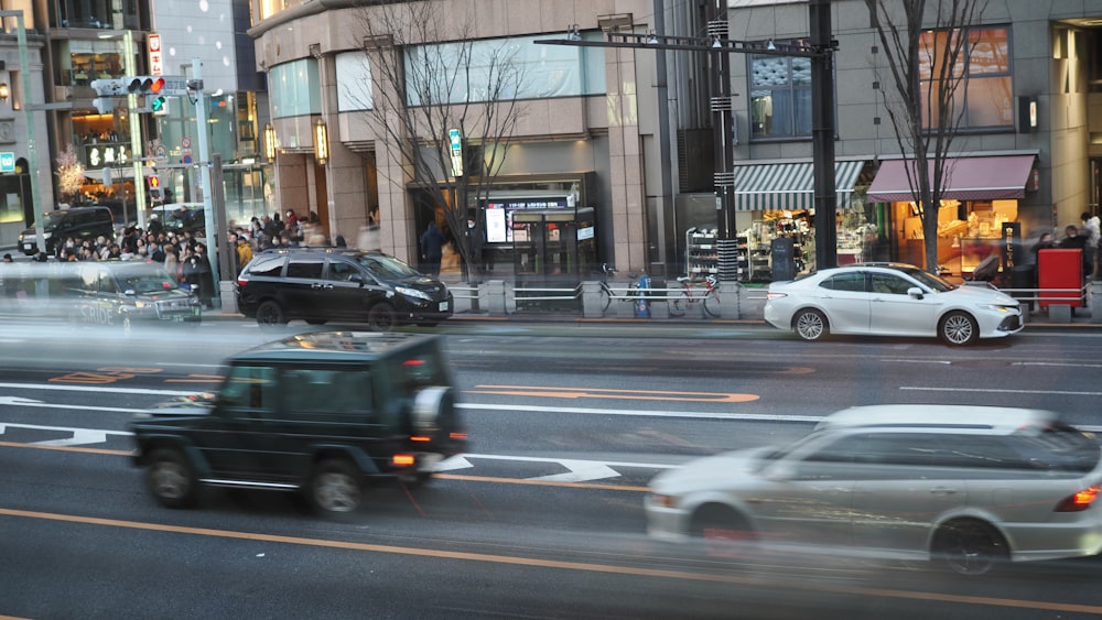 a car driving down a street next to tall buildings