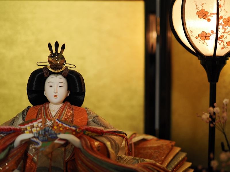Geisha figurine beside lamp