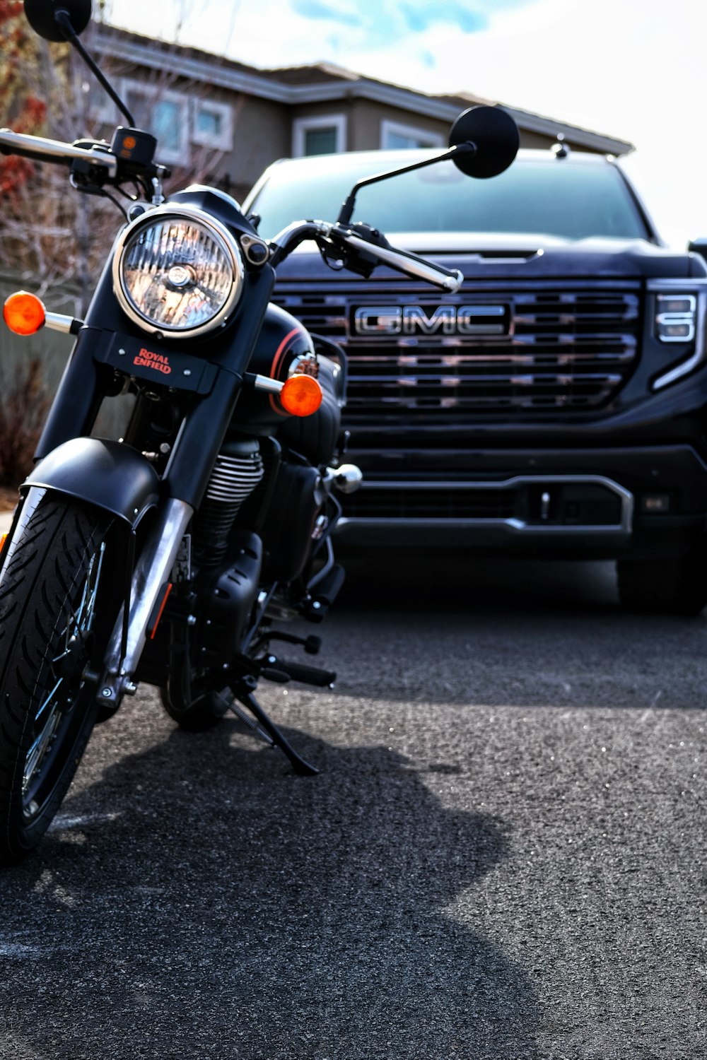 a black motorcycle parked next to a black truck