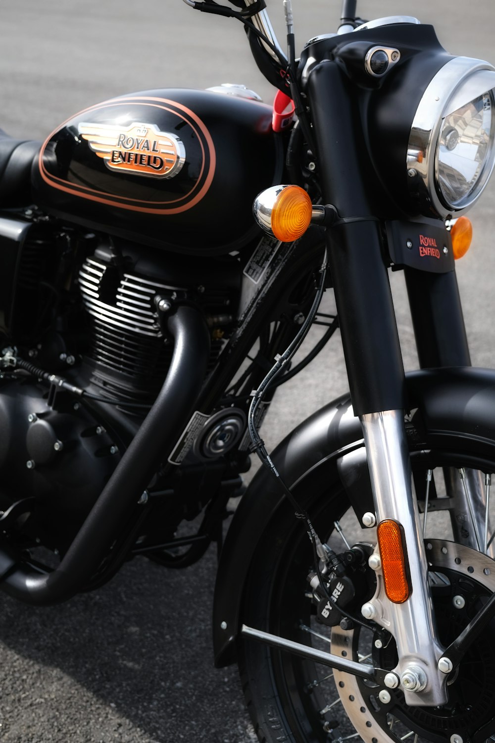 a close up of a motorcycle parked on the street