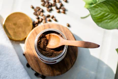 a wooden spoon is in a jar of coffee