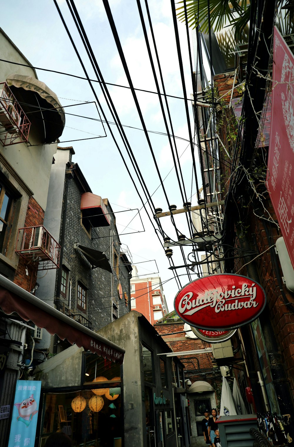 a street with a bunch of wires above it