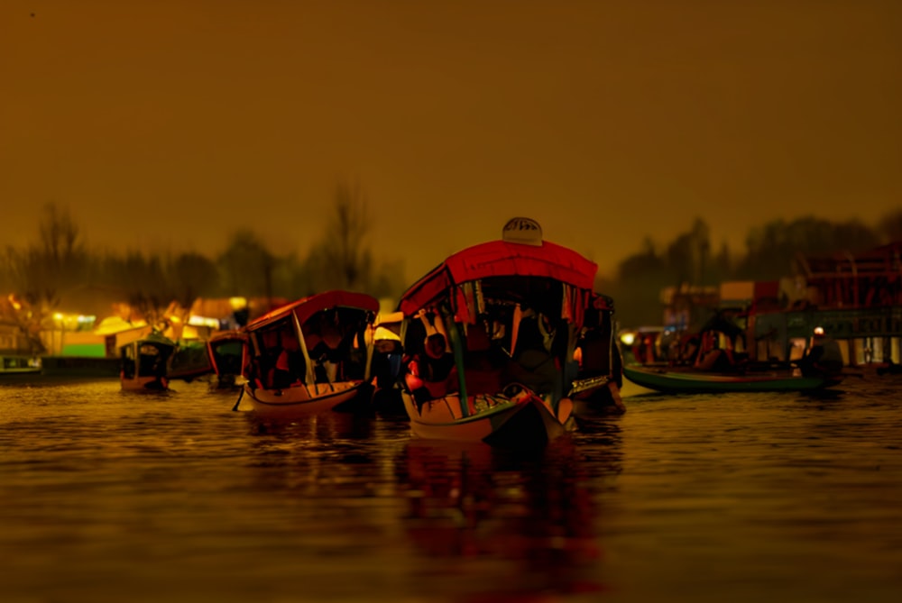 a group of boats floating on top of a body of water