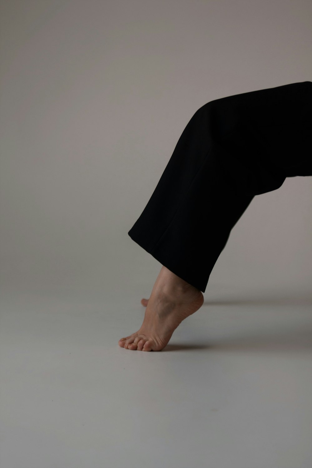a person doing a hand stand on their feet