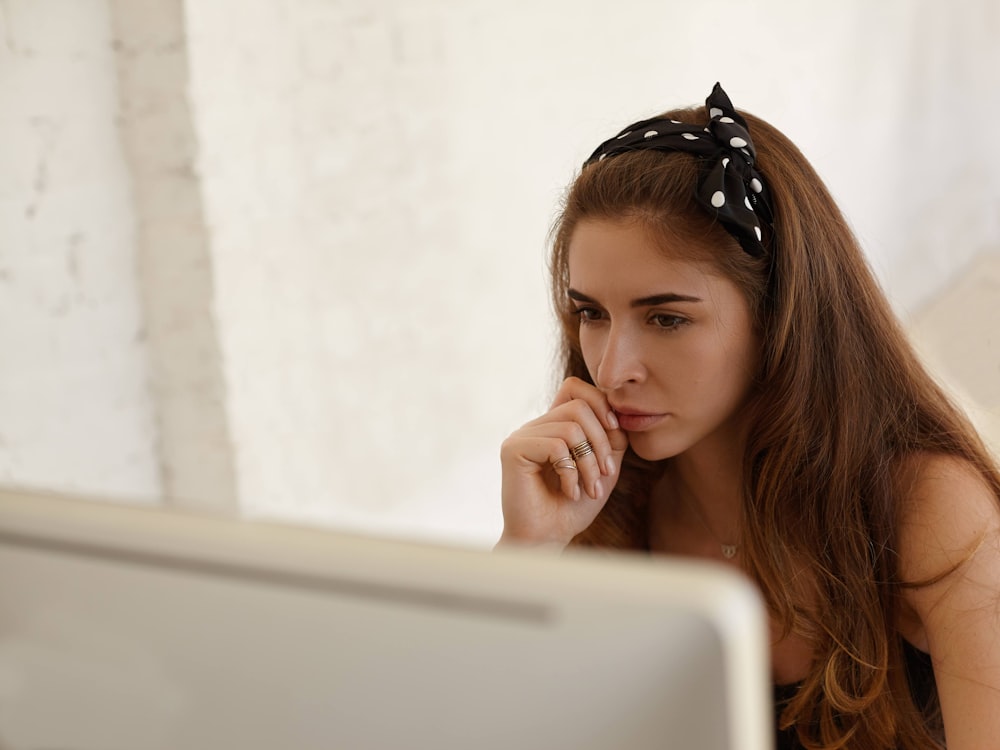 a woman sitting in front of a laptop computer