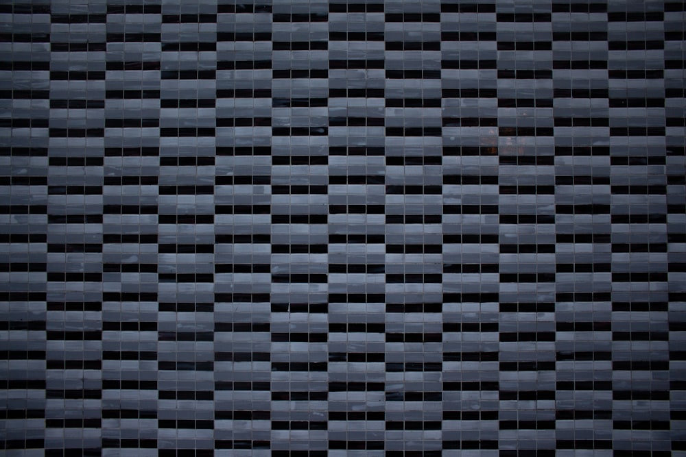 a black and white tiled wall with squares