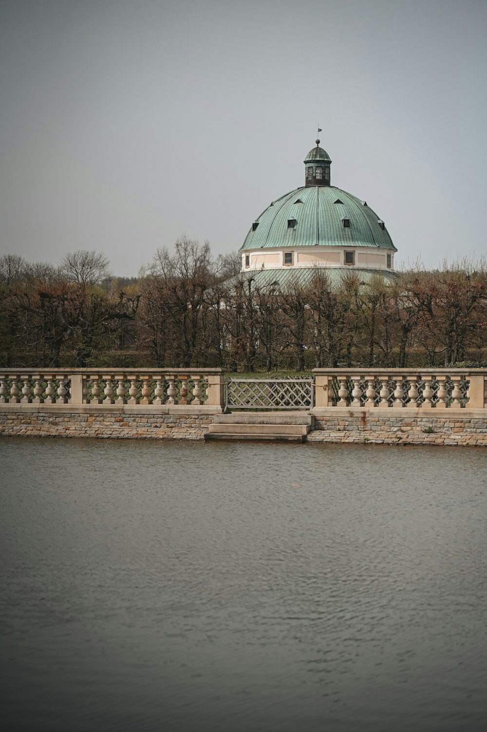 a large body of water with a building in the background