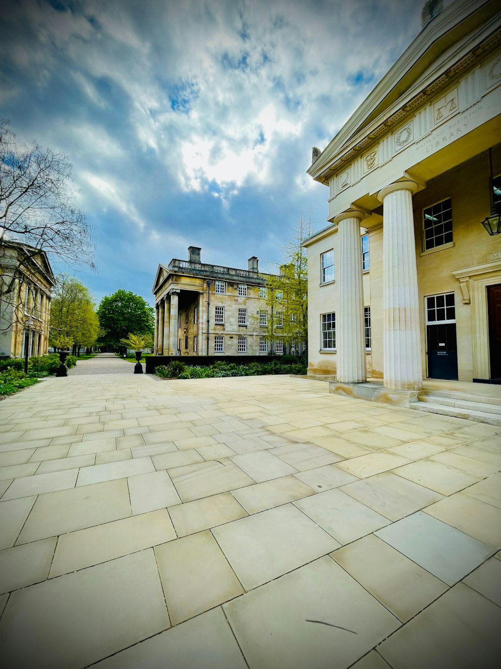 a large building with columns and a sky background