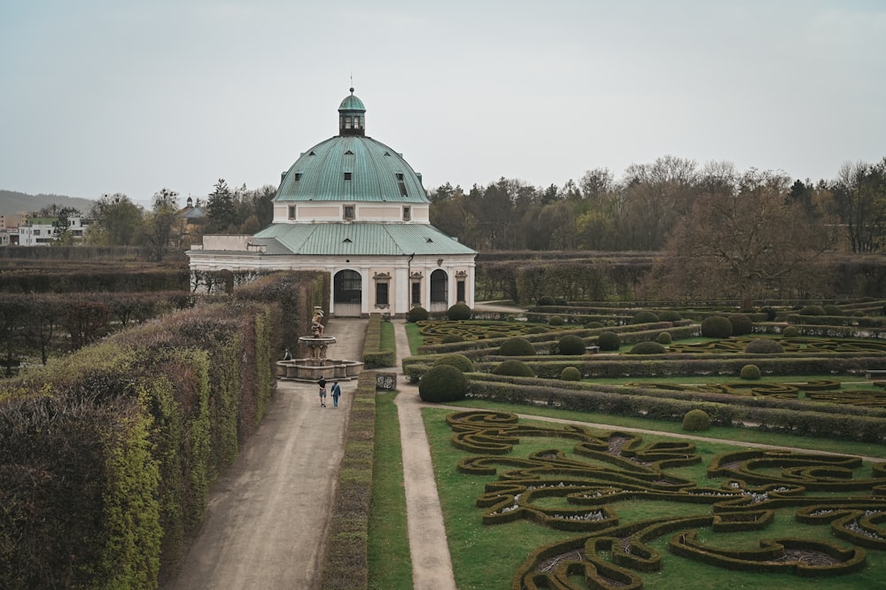 a large white building with a green roof