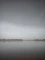 a large body of water sitting under a cloudy sky